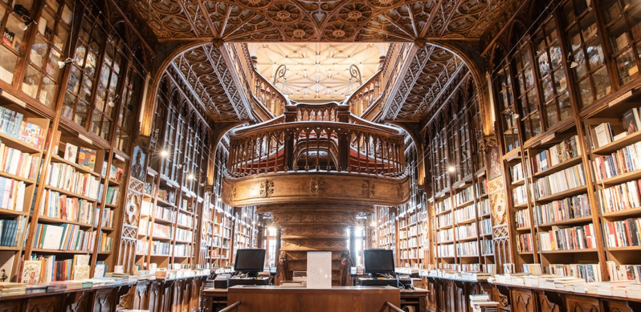 Interior de biblioteca histórica com estantes e arquitetura detalhada, representando o valor cultural destacado no Dia Nacional da Biblioteca.