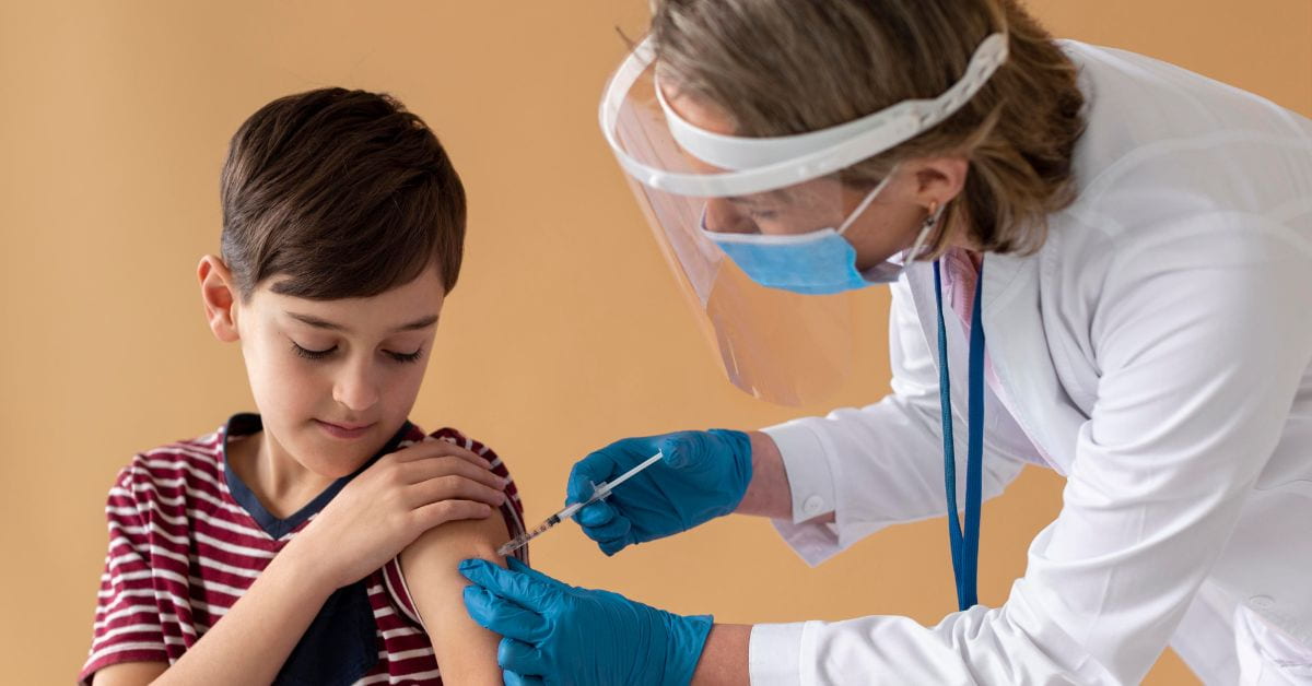 Menino recebendo vacina no braço durante a vacinação contra a gripe