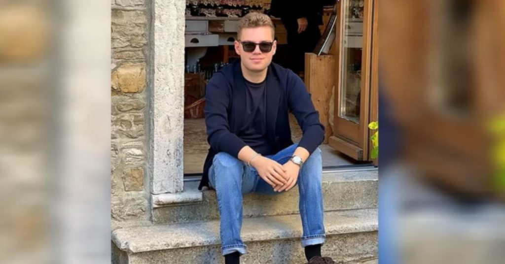 Luka Krizanac sentado na escada de uma loja, sorrindo, após transplante de mãos que lhe devolveu autonomia e qualidade de vida