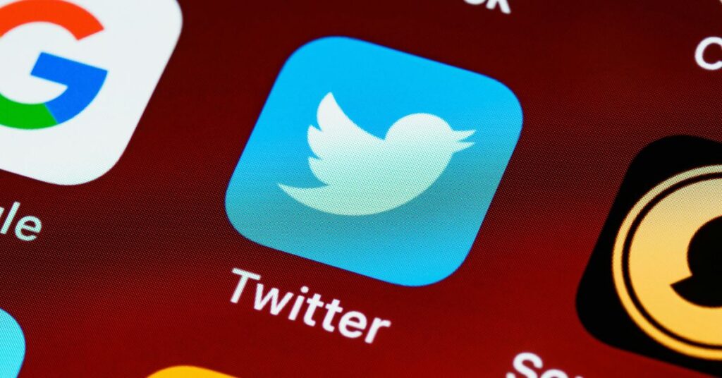 marca Twitter representada pelo ícone do pássaro azul em tela de smartphone
