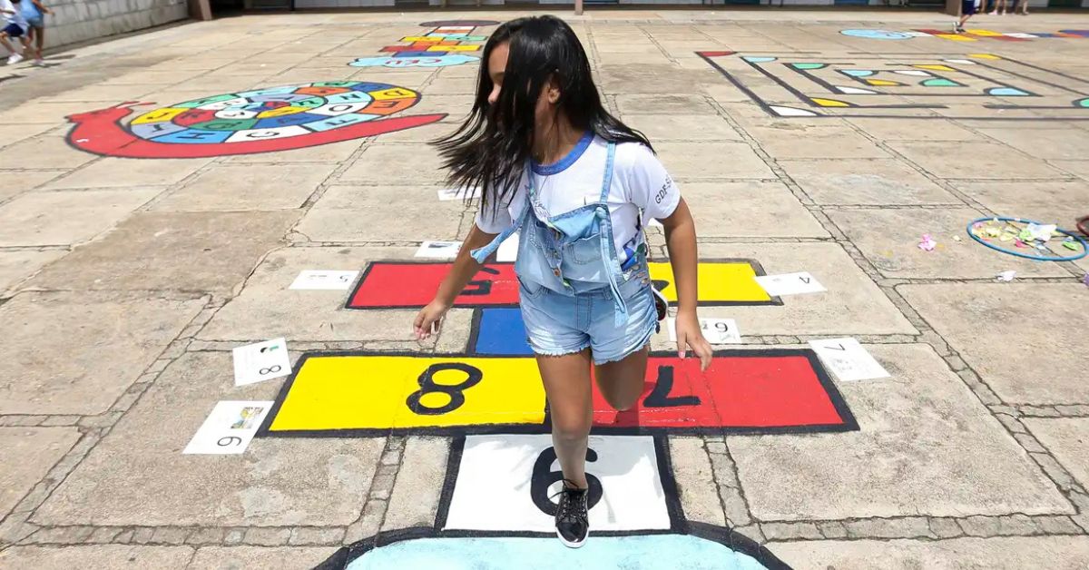 Criança brinca em pátio escolar enquanto CNJ amplia adoção tardia com aplicativo de busca ativa