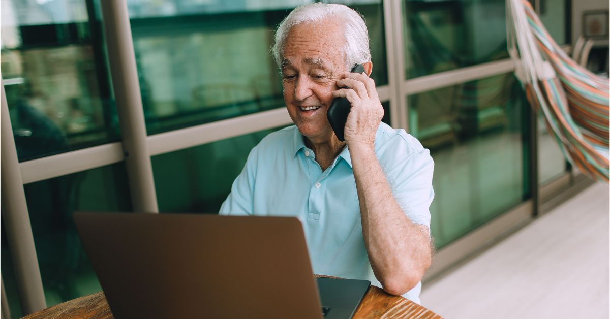 Idoso utiliza notebook e celular durante chamada, ilustrando o crescimento do acesso à internet idosos Ceará entre pessoas com 60 anos ou mais.